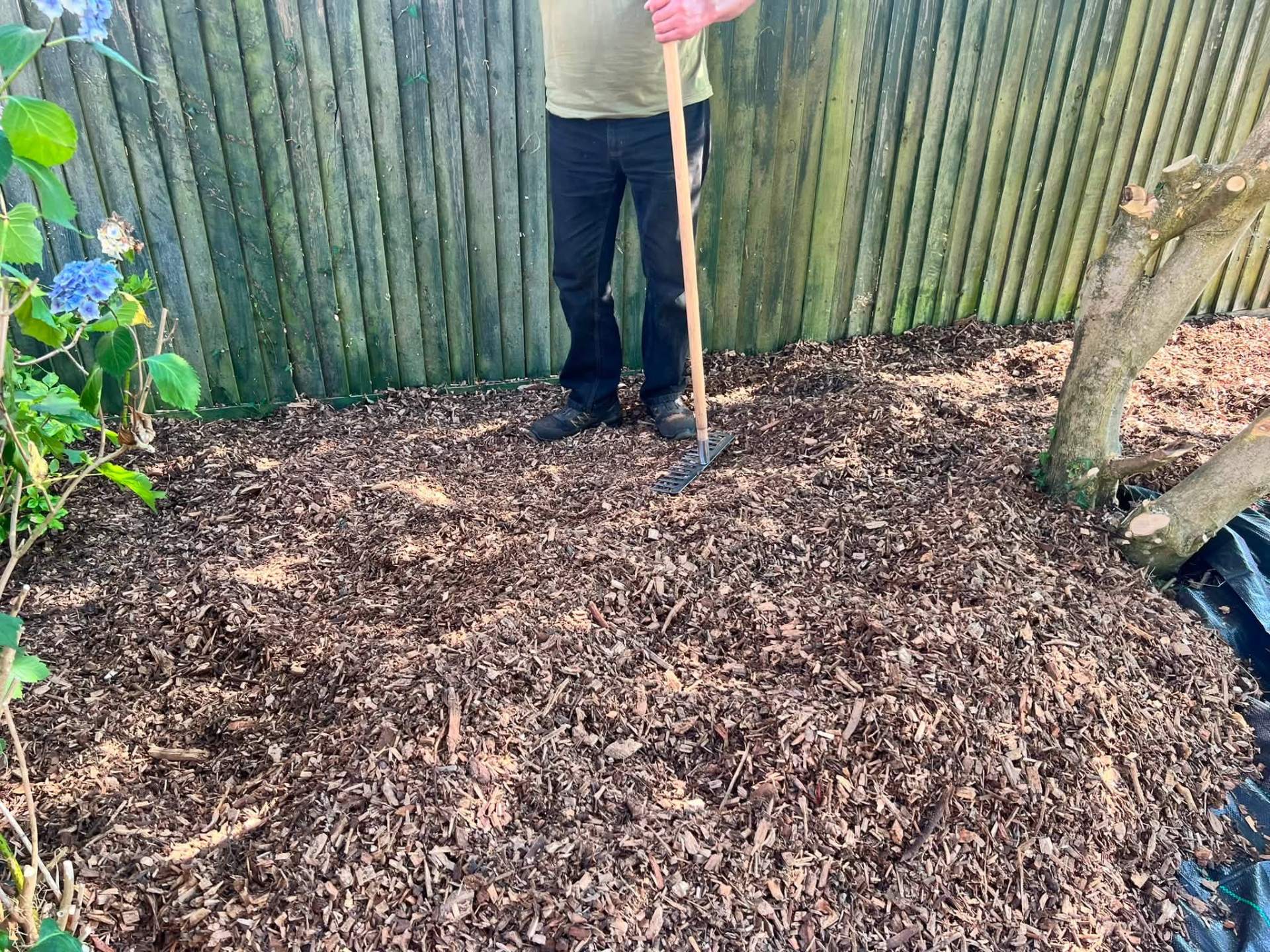 Fresh bark mulch bed installation