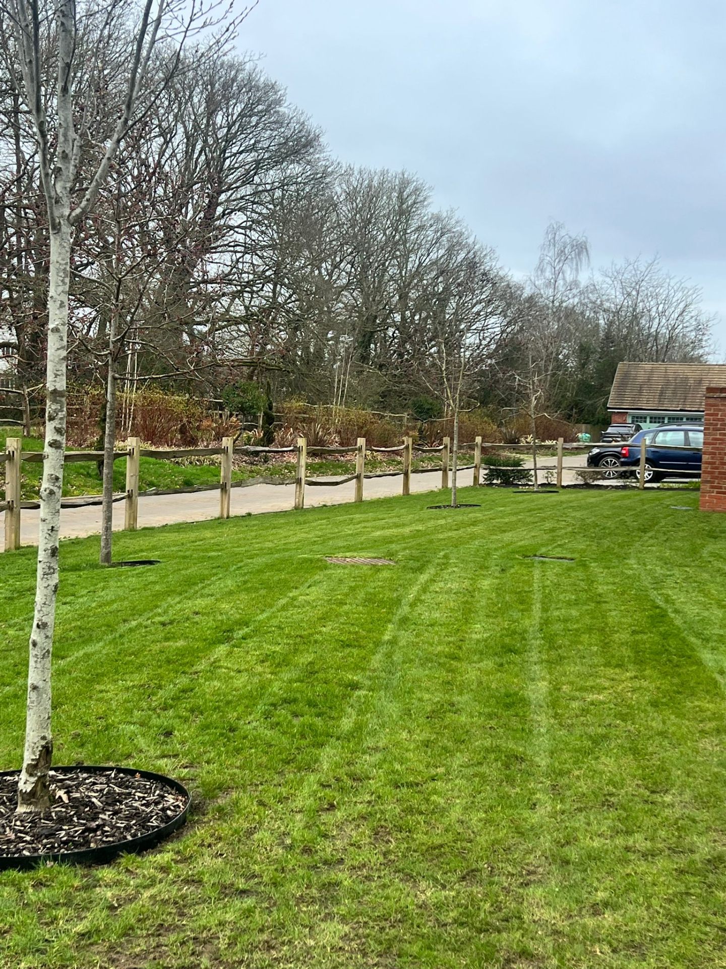 Fresh turf lawn & post & rail fencing